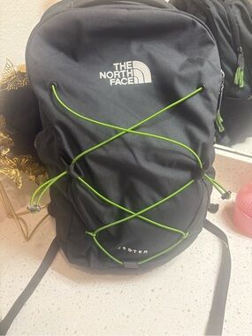 The North Face Black Backpack with Green Bungee Cord